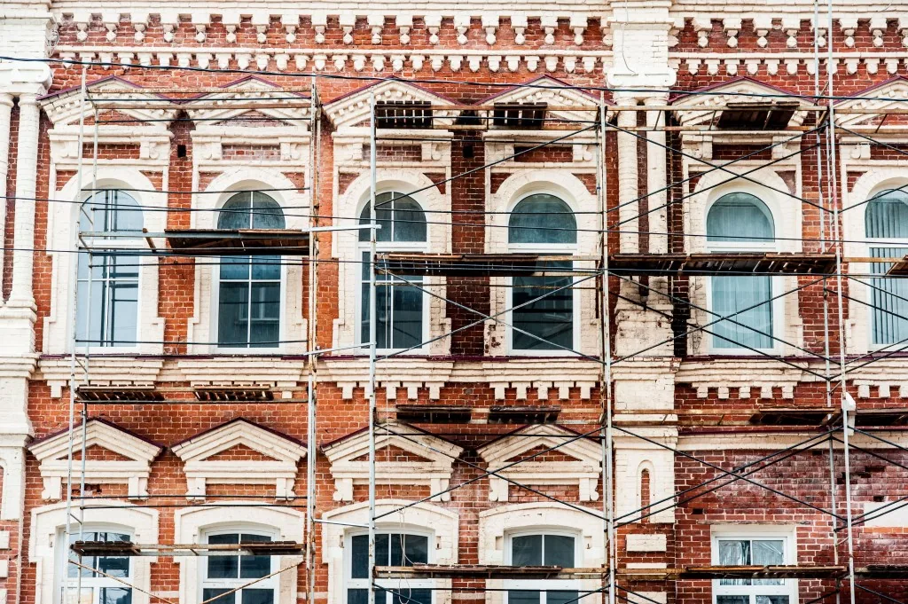 Brick façade of a historic building under scaffolding