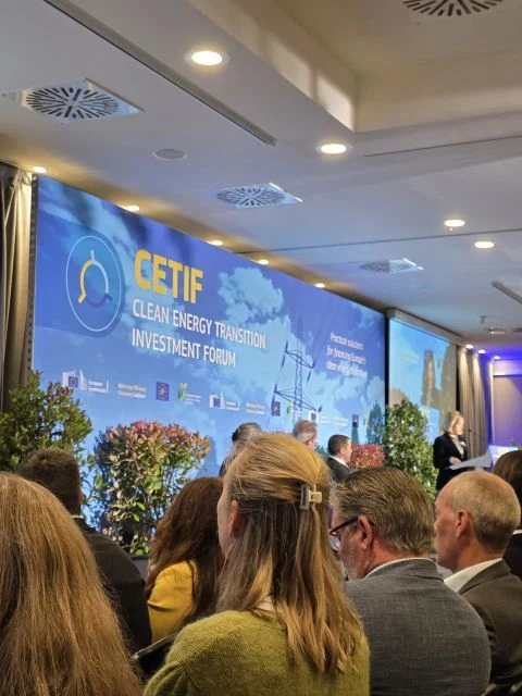 Audience facing the stage at the Clean Energy Transition Investment Forum 2025, with the forum’s name on the screen