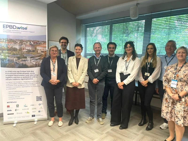 Participants of the EPBD.wise policy forum in Budapest standing beside the project banner